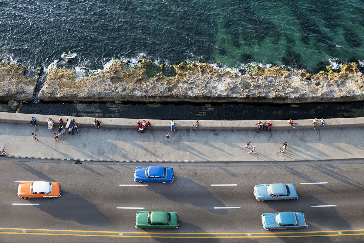 Drive along a seaside road on tailor made holidays in Cuba