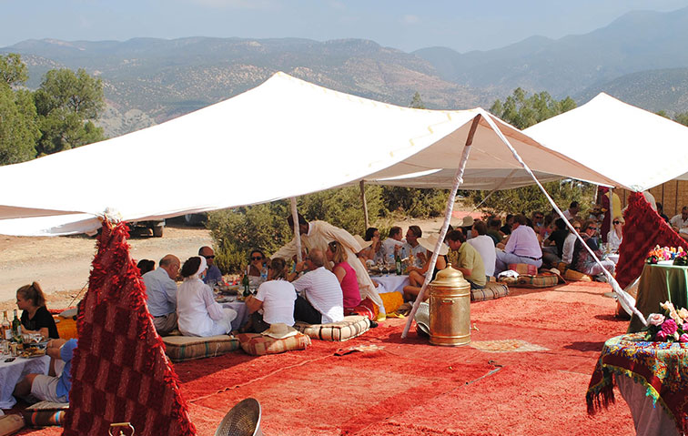 people sitting under a white canopy