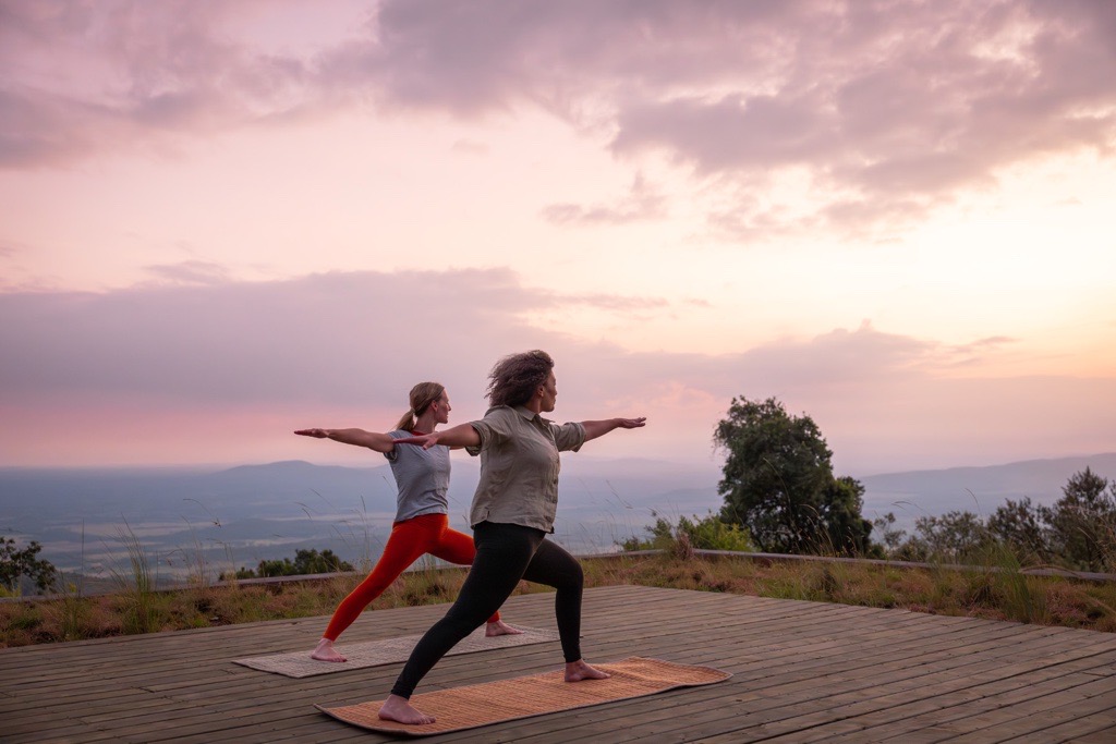 two ladies doing yoga in wild hill, kenya