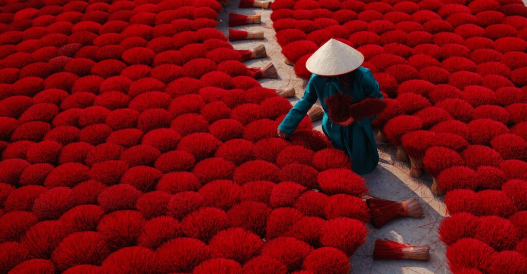 Local worker drying colourful incense sticks in a traditional incense village in Vietnam