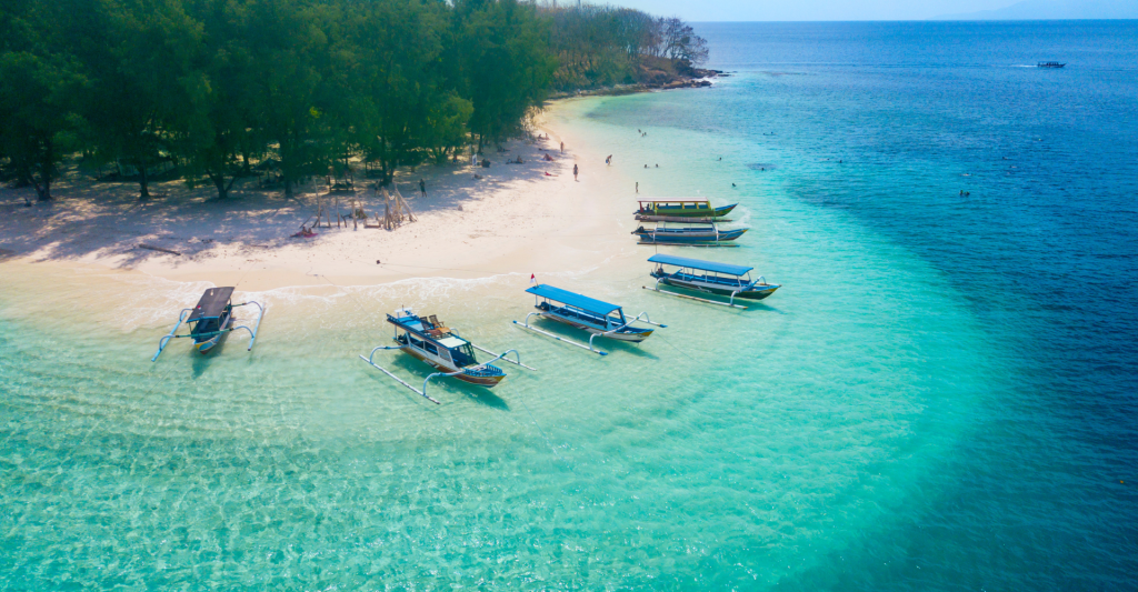 Boats on turquoise waters around an Indonesian island