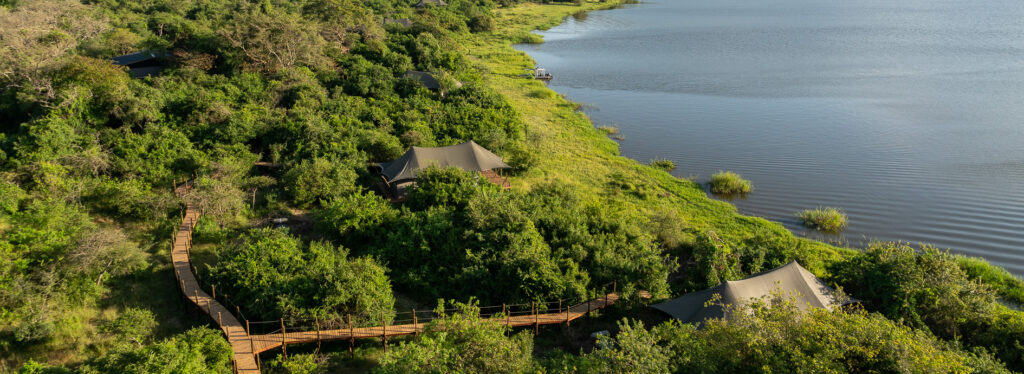 Magashi Camp hotel at the edge of a crescent shaped bay in Rwanda.